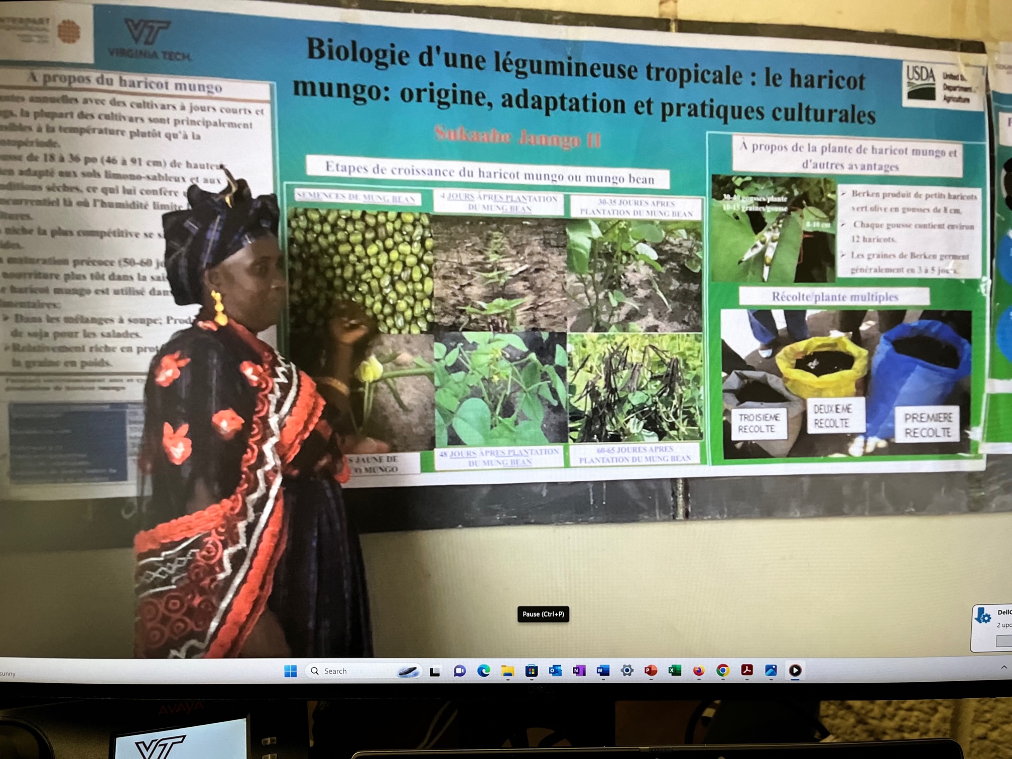 Bineta Kane standing in a classroom sharing her experience growing mung bean with the community.